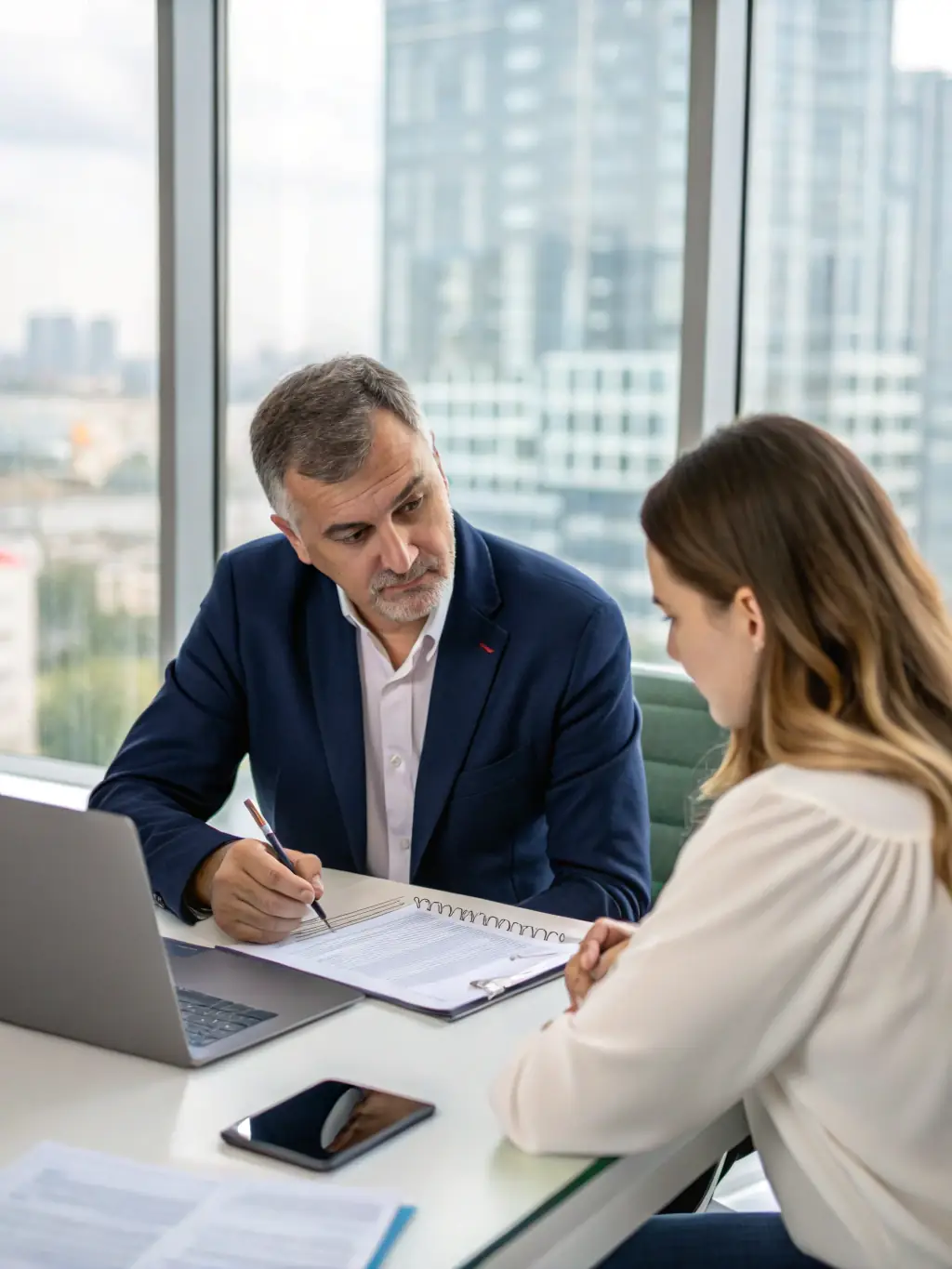 A friendly insurance agent sitting at a desk, reviewing policy options with a young couple, emphasizing personalized service and attention to detail.